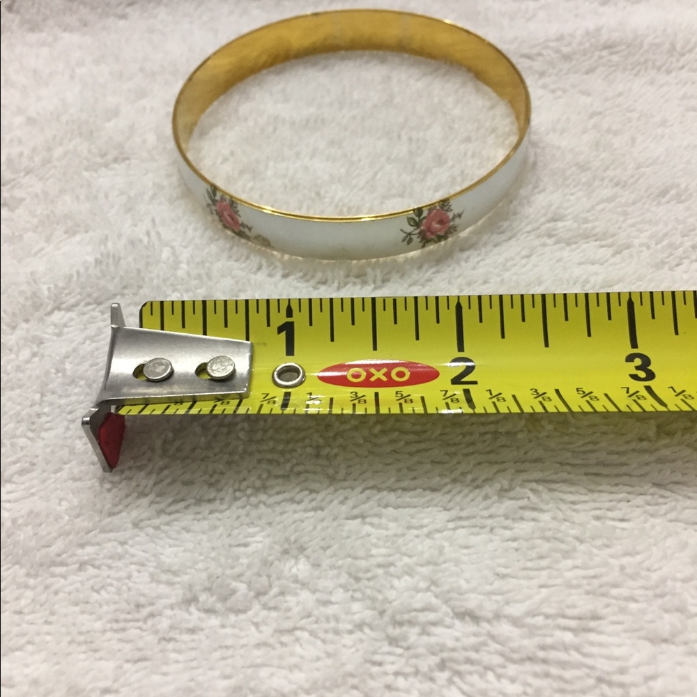 Set of 3 circular metal bracelets.